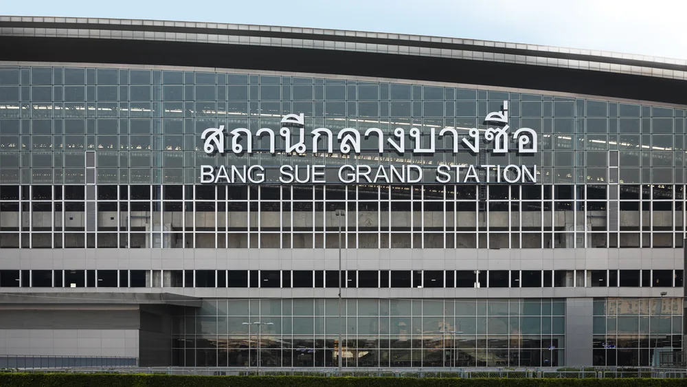 Central Station's glass facade and curved roof, with large lettering displaying the Thai station name and BANG SUE GRAND STATION