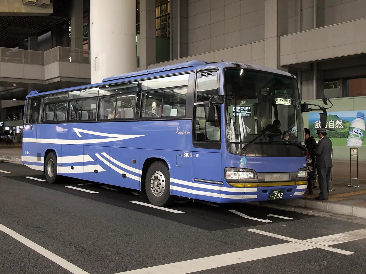 A limousine bus in Kansai Airport Transportation livery at the Kansai Airport bus stop