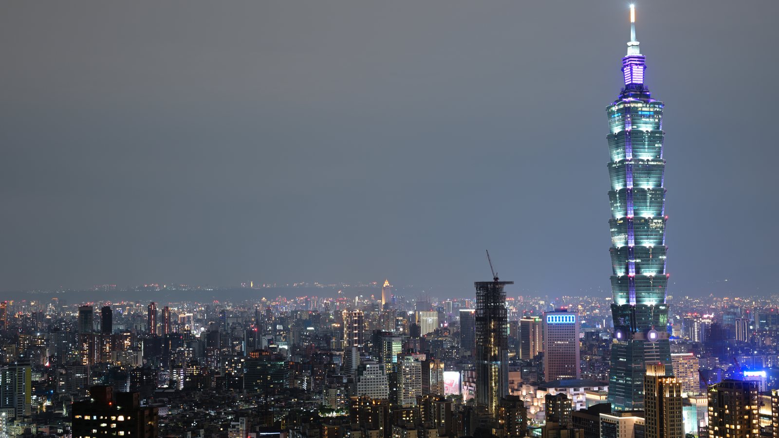 Taipei skyline with Taipei 101 lit up at night, seen from the Elephant Mountain trail