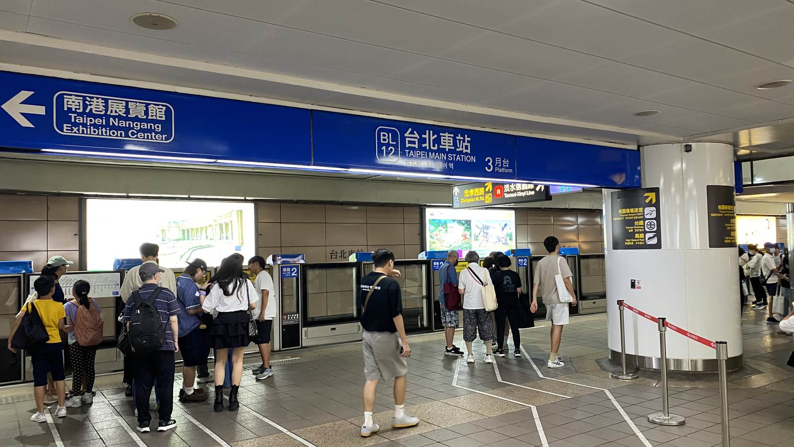 Passengers queuing on painted lines at the platform doors of Taipei Main Station on the Taipei Metro Blue Line