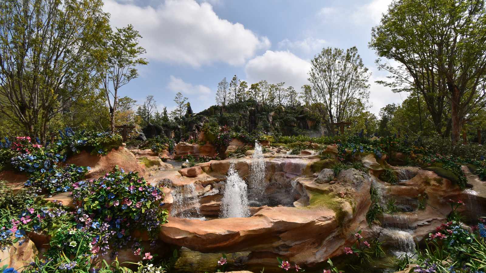 Fantasy Springs at Tokyo DisneySea, with rocky mountains, fountains, and fairy-tale buildings